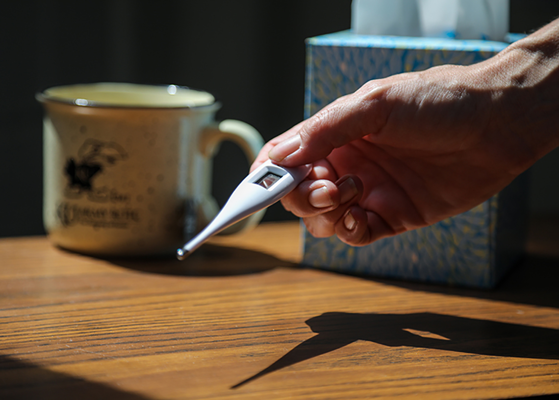 Stock image of thermometer, tissues, cup of tea